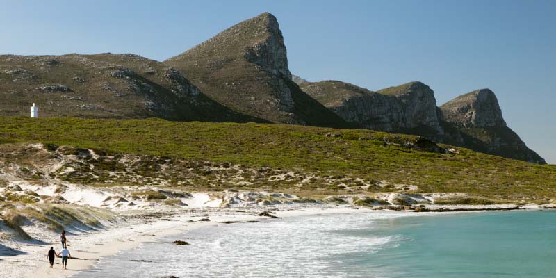 A family walking along the shore of Buffels bay