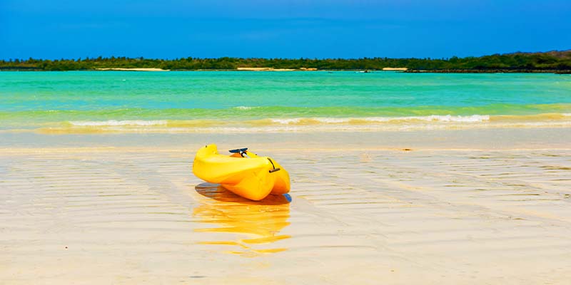A kayak laying on the beach