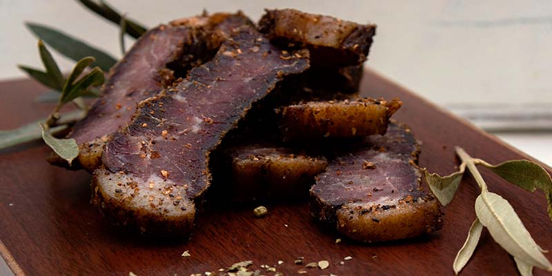 Biltong laid out on a wooden serving platter