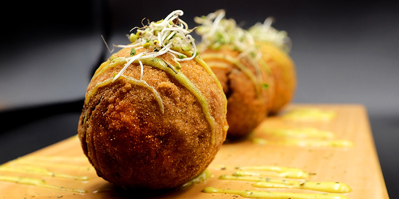 Bolon de verde served on a wooden dish