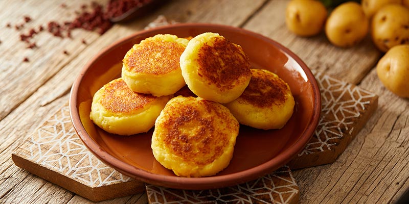 Stacked Llapingachos on a plate