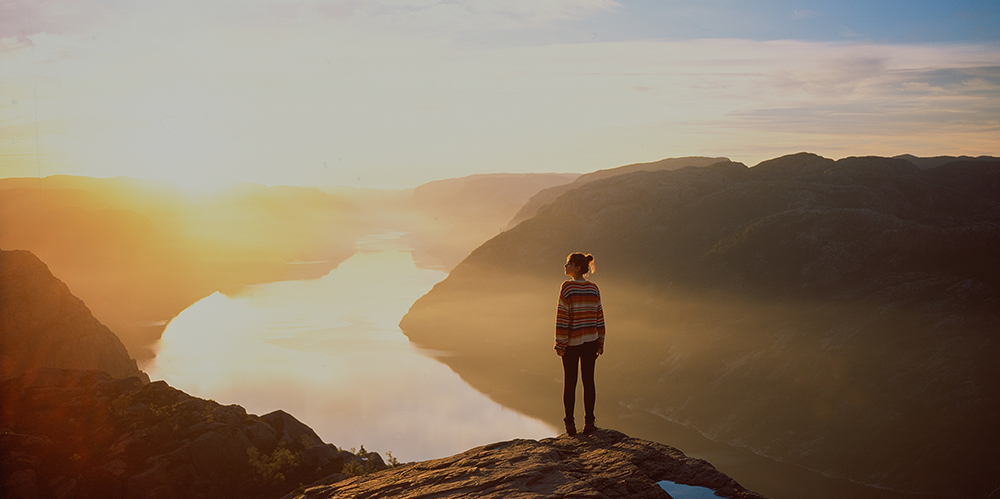Woman standing atop a fjord in Lysefjord