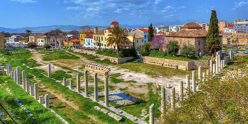 The Ancient Agora ruins with the city in the background