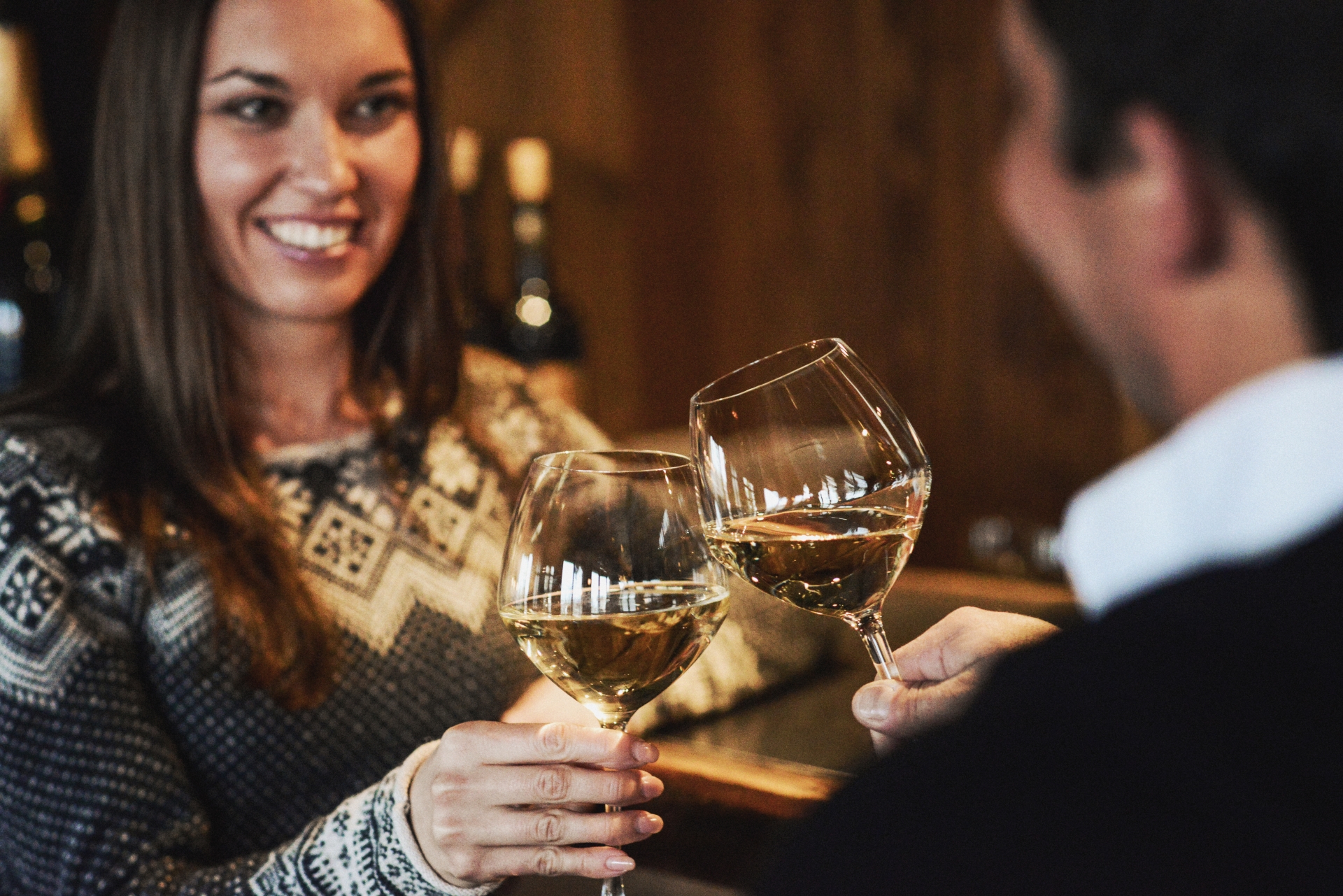 Two people drinking wine in Le Chalet De Pierres
