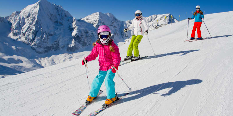 a couple of teens skiing 