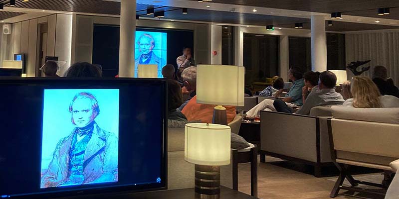 People on a Galapagos cruise receiving a lecture on sustainability