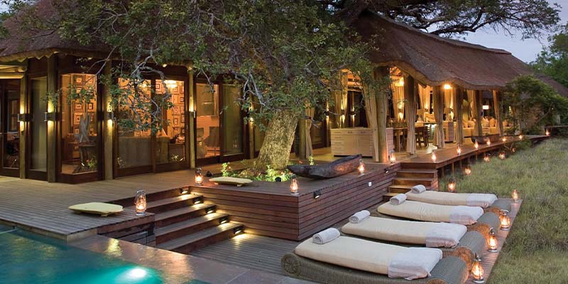 Outdoor area of a lodge with tanning beds and a pool