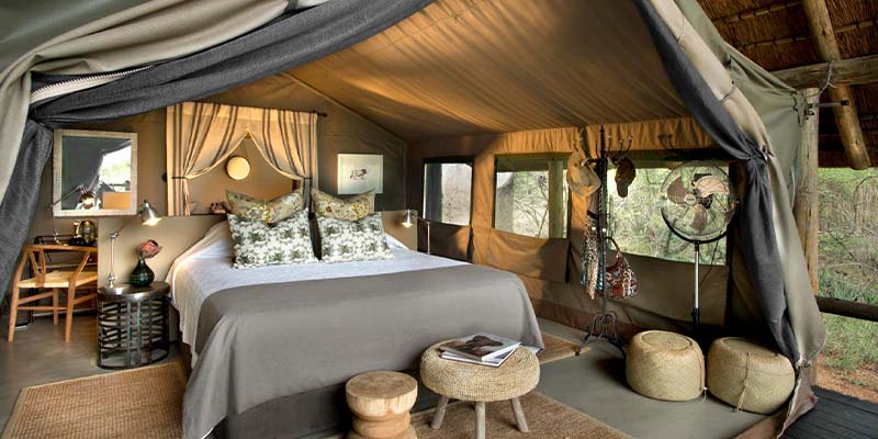 A bedroom inside of a glamping tent