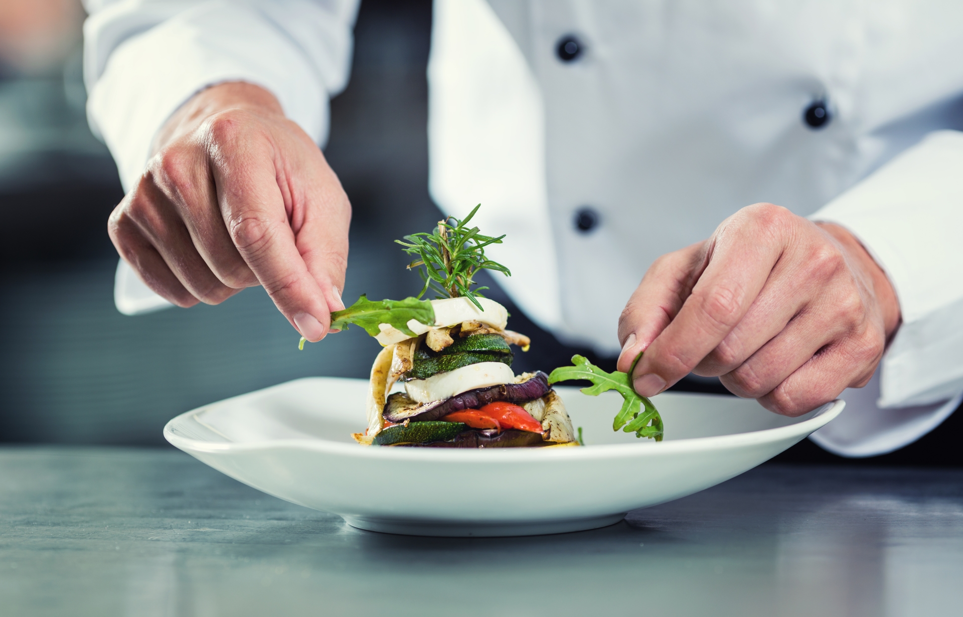 Chef preparing a plate at a Michelin star restaurant