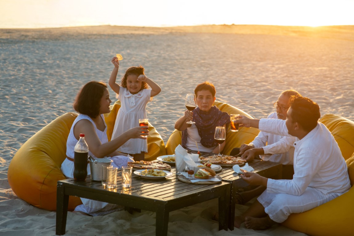 a family having a meal on the beach