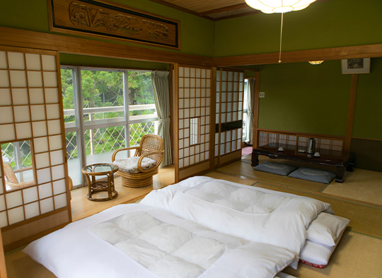 A bedroom with two tatami mats overlooking some trees