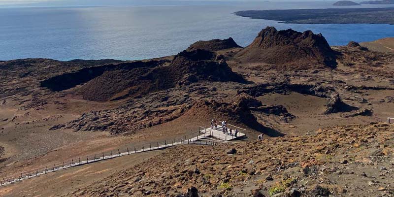 Visitors look out at the surrounding ocean from a viewpoint