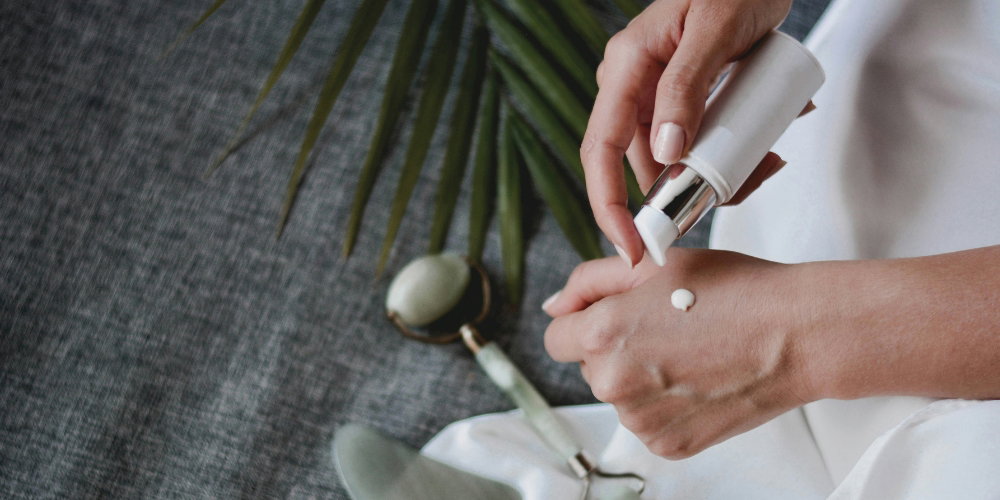 A person putting lotion on their hand