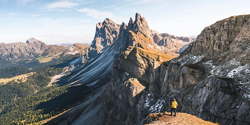 A hiker standing on the edge of the Dolomites