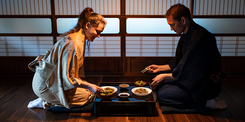 A man and woman eating dinner at a ryokan