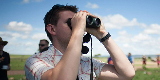 Bjorn looking through Binoculars
