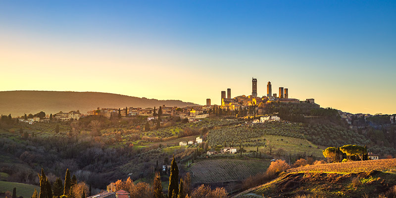 Sun setting over a hilltop Tuscan village