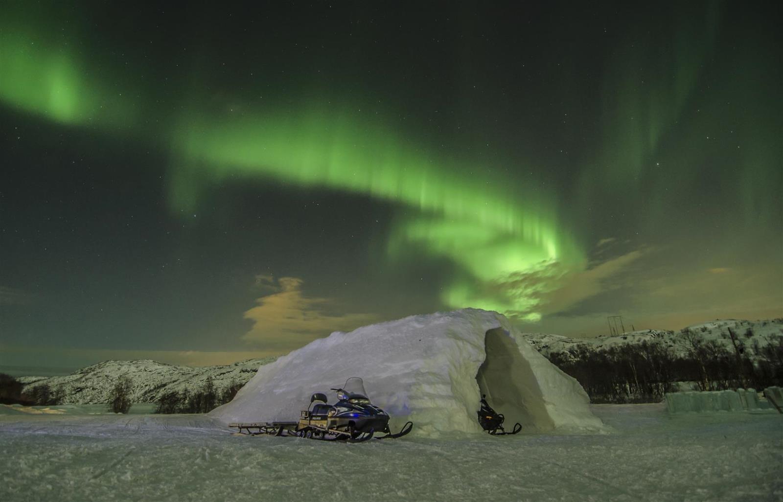 Kirkenes Snow hotel in Norway under the northern lights at night