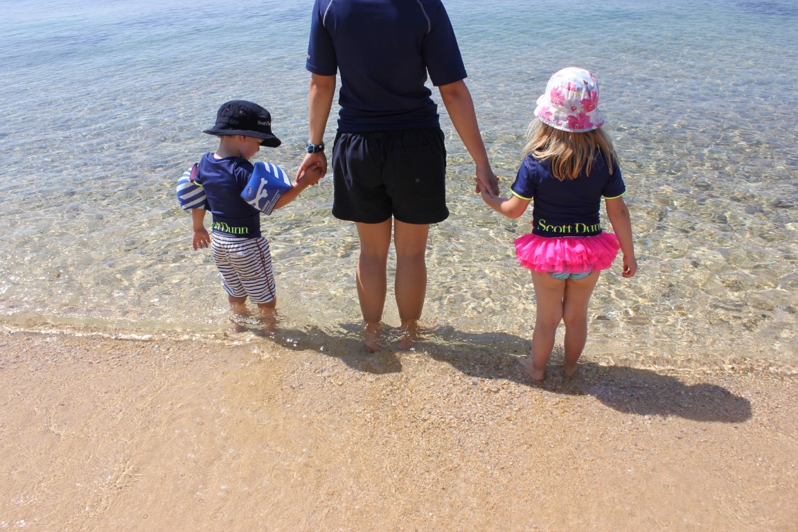 Scott Dunn Explorers staff with toddlers on the beach