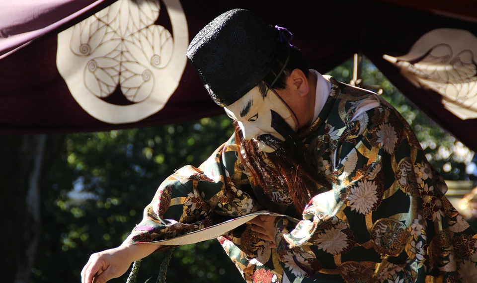 A man wearing a mask performing on stage
