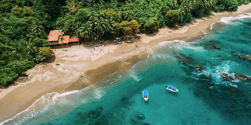 A hut and boats by the ocean 