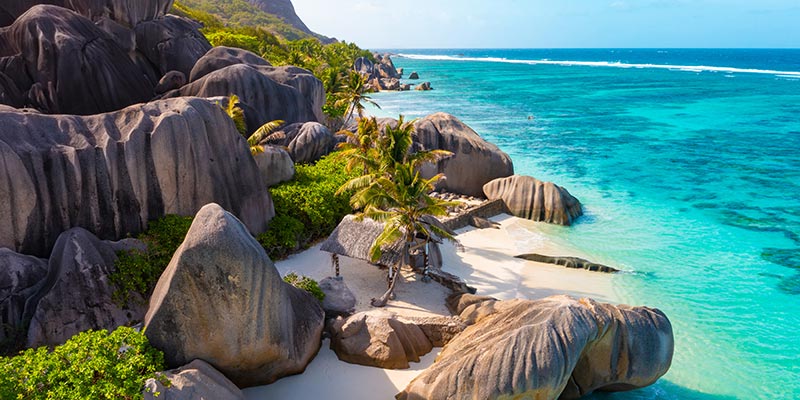 A rocky cliffside and clear ocean water