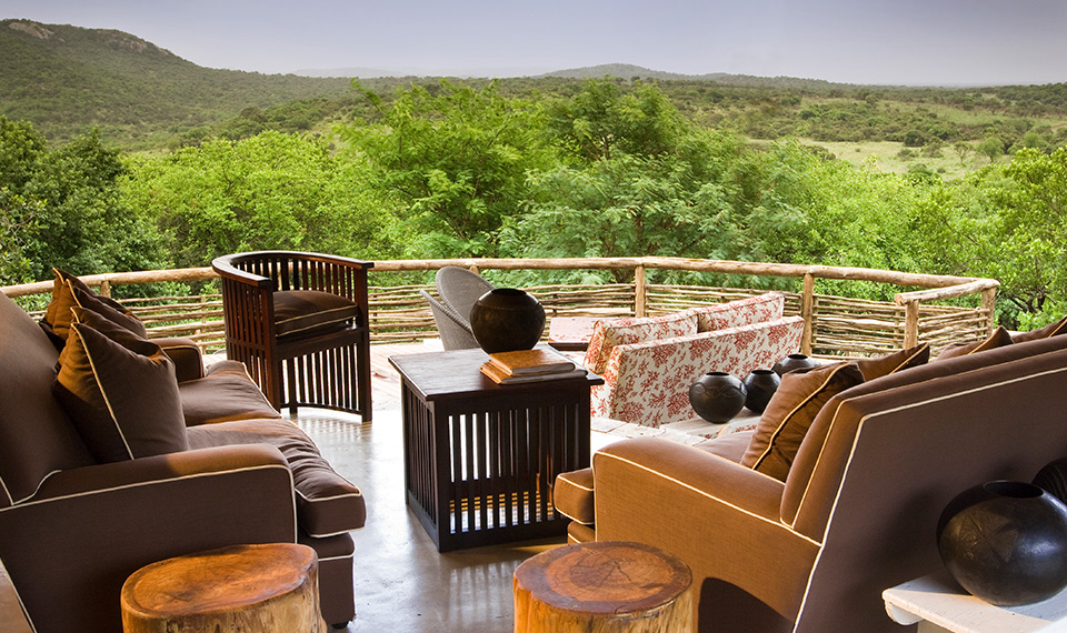  An outdoor balcony overlooking green trees and mountains 
