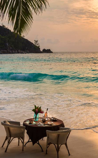 Table set up for romantic dinner on a beach