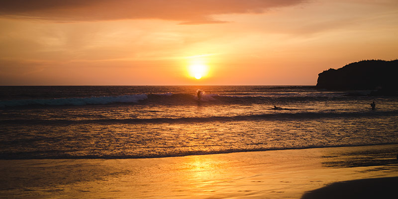 People surfing at sunset