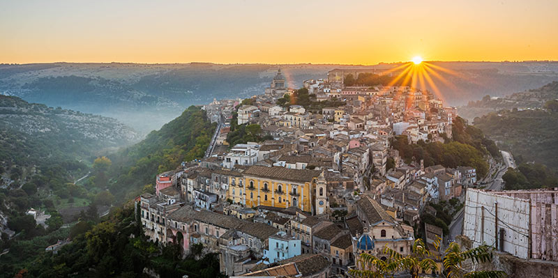 Sun setting over the town Ragusa