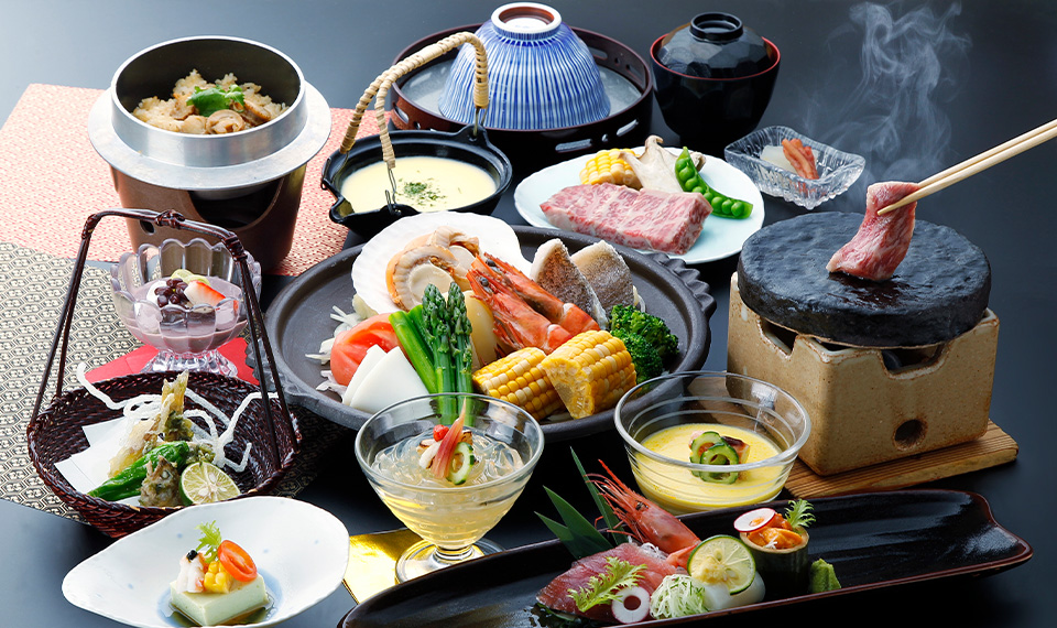 Multiple dinner dishes consisting of vegetables, meat, and seafood centred on a table