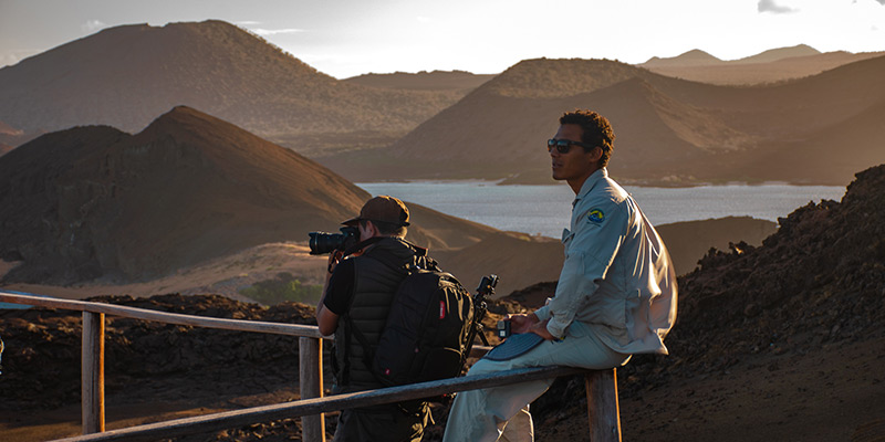 A guide sitting on the bow of the Endemic ship