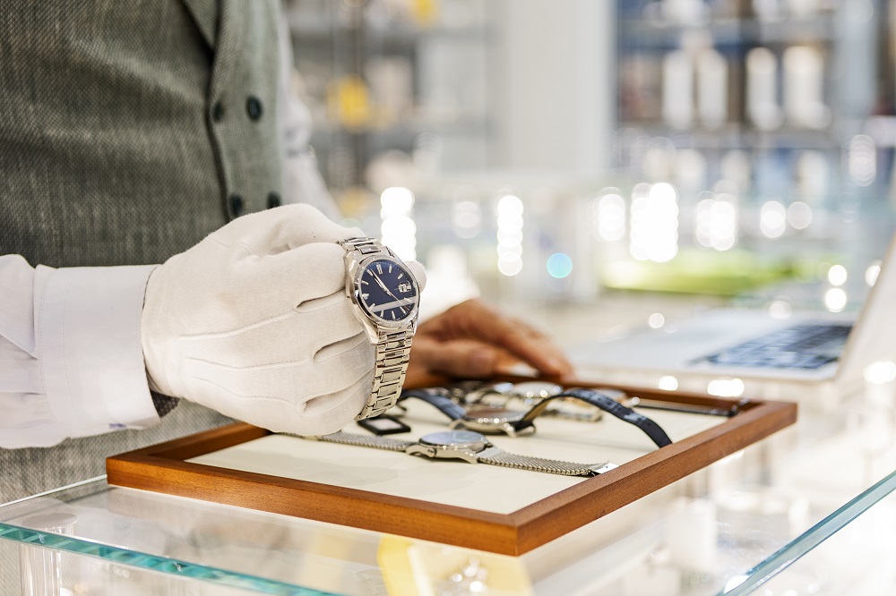 A man showcasing a luxury watch